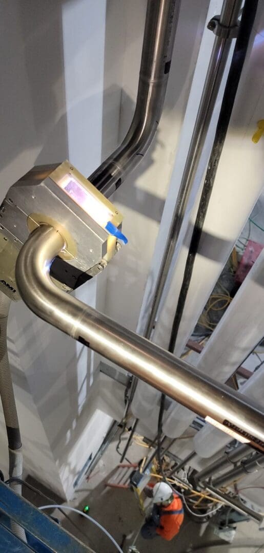 AMI orbital weld head on overhead stainless tube in a new facility
