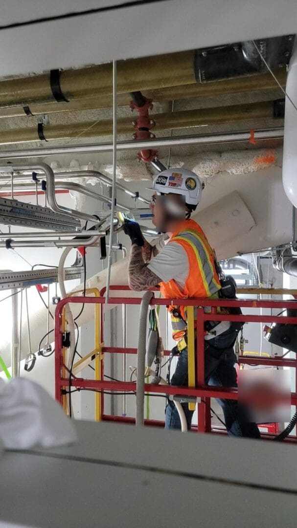 TIG technician helping a customer with a tight-access overhead weld