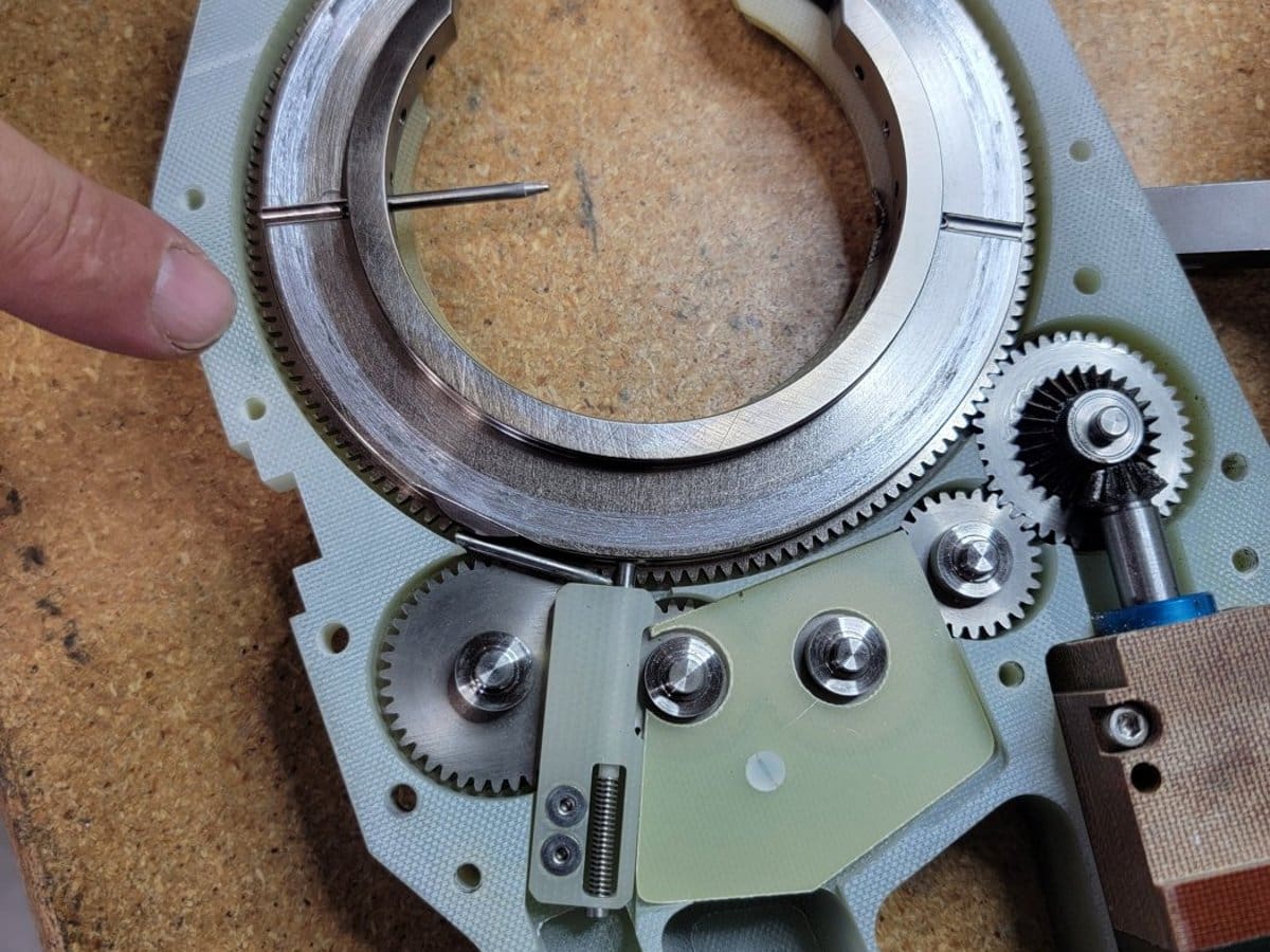 Orbital weld head opened up on the bench, gears and rotor exposed